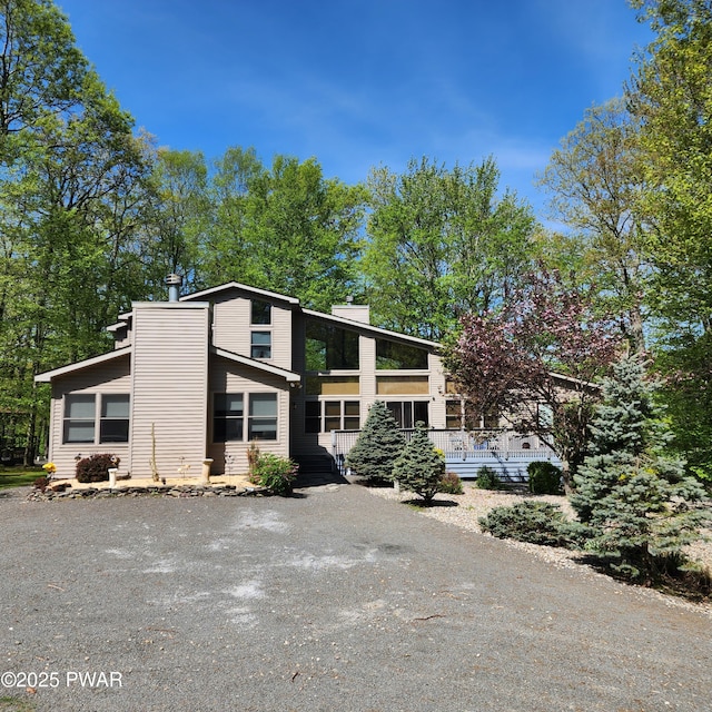 344 Canoebrook Dr, Lords Valley, PA 18428 - mid-century modern home featuring a chimney and gravel driveway