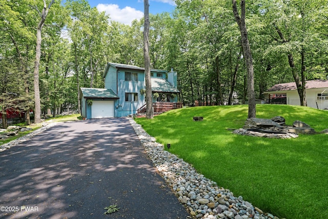 103 Westfall Dr, Dingmans Ferry, PA 18328 - view of front of property with asphalt driveway, a front yard, and a chimney
