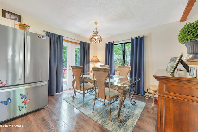 103 Westfall Dr, Dingmans Ferry, PA 18328 - dining area featuring healthy amount of natural light, dark wood-style flooring, a textured ceiling, and a chandelier