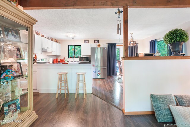 103 Westfall Dr, Dingmans Ferry, PA 18328 - kitchen featuring stainless steel appliances, a peninsula, and dark wood-style flooring