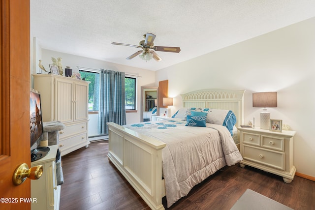 103 Westfall Dr, Dingmans Ferry, PA 18328 - bedroom with dark wood-style flooring, a textured ceiling, ceiling fan, and a baseboard heating unit