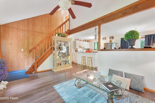 103 Westfall Dr, Dingmans Ferry, PA 18328 - living room with wooden walls, stairway, wood finished floors, a ceiling fan, and a high ceiling