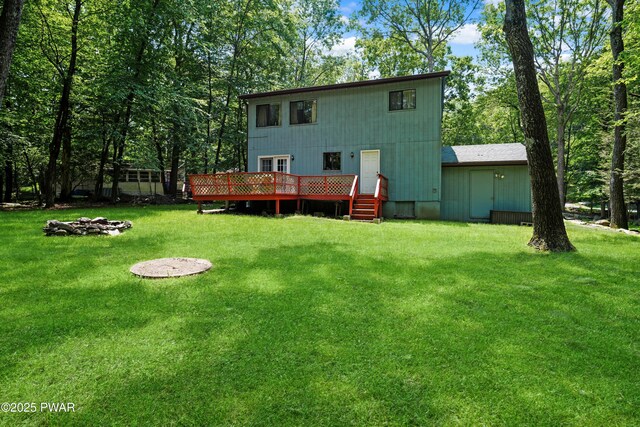 103 Westfall Dr, Dingmans Ferry, PA 18328 - rear view of house featuring a wooden deck and a lawn