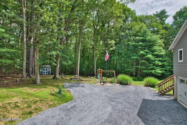 142 Myck Rd, Dingmans Ferry, PA 18328 - view of yard featuring a shed, a playground, stairway, and driveway