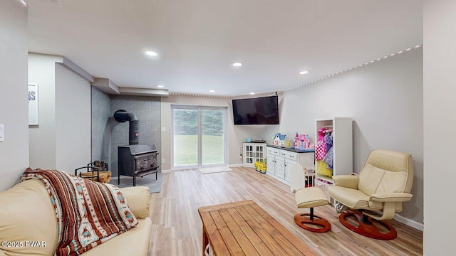 142 Myck Rd, Dingmans Ferry, PA 18328 - recreation room with a wood stove, light wood-type flooring, and recessed lighting