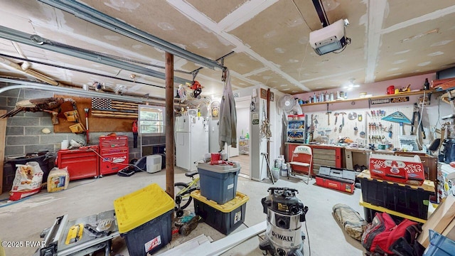 142 Myck Rd, Dingmans Ferry, PA 18328 - garage with a workshop area, a garage door opener, and freestanding refrigerator