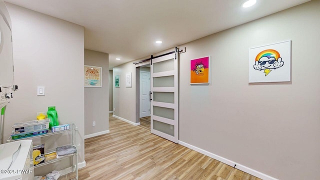 142 Myck Rd, Dingmans Ferry, PA 18328 - hall featuring a barn door, light wood-style flooring, and recessed lighting