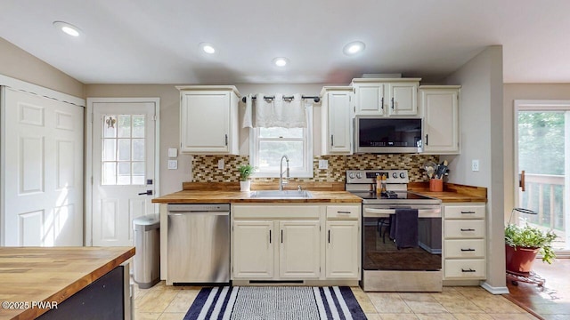142 Myck Rd, Dingmans Ferry, PA 18328 - kitchen featuring stainless steel appliances, butcher block counters, tasteful backsplash, white cabinets, and recessed lighting