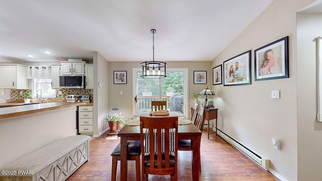 142 Myck Rd, Dingmans Ferry, PA 18328 - dining space with baseboard heating, healthy amount of natural light, wood finished floors, a chandelier, and recessed lighting