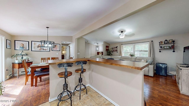 142 Myck Rd, Dingmans Ferry, PA 18328 - kitchen with open floor plan, butcher block counters, a chandelier, and wood finished floors