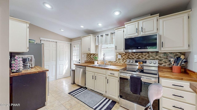 142 Myck Rd, Dingmans Ferry, PA 18328 - kitchen with stainless steel appliances, wooden counters, tasteful backsplash, vaulted ceiling, and recessed lighting