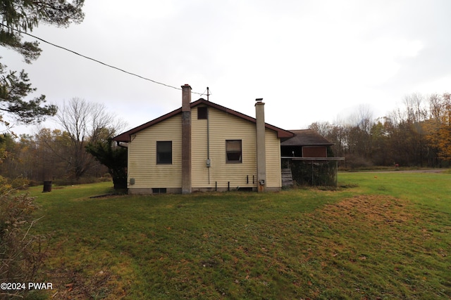 view of side of home featuring a yard