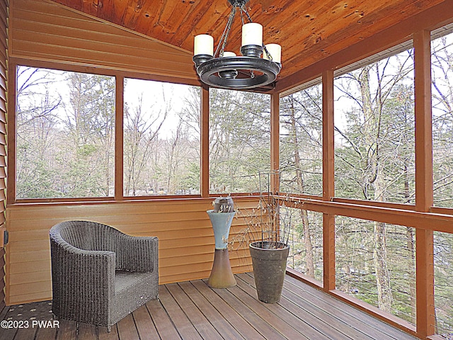 unfurnished sunroom featuring a healthy amount of sunlight, wood ceiling, and lofted ceiling