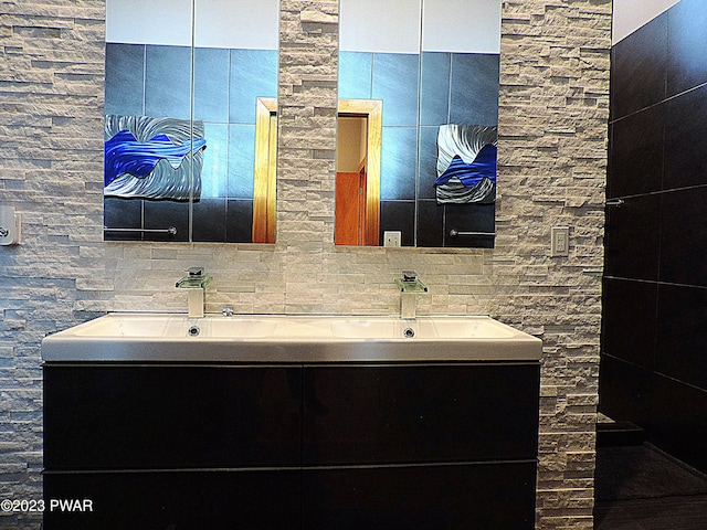 bathroom with vanity and tasteful backsplash