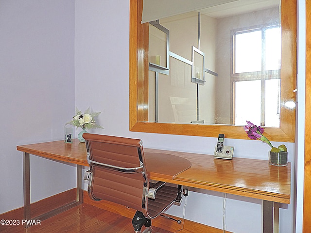 office area featuring hardwood / wood-style floors and built in desk