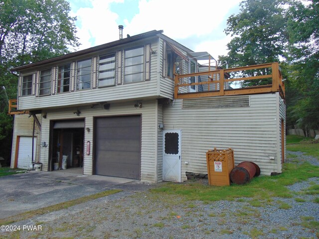 exterior space with a garage and a balcony