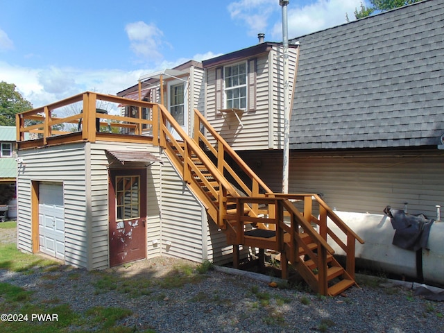 back of property with a garage