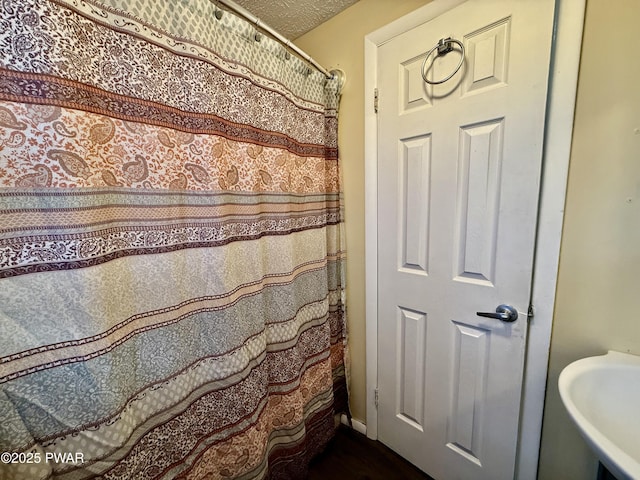 bathroom with sink and a textured ceiling