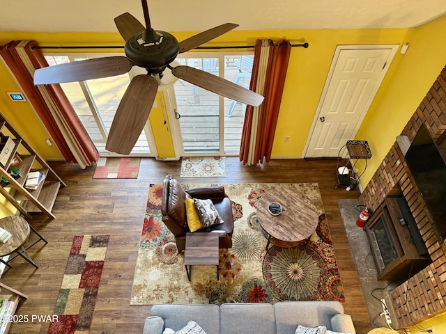 living room featuring ceiling fan and dark hardwood / wood-style floors