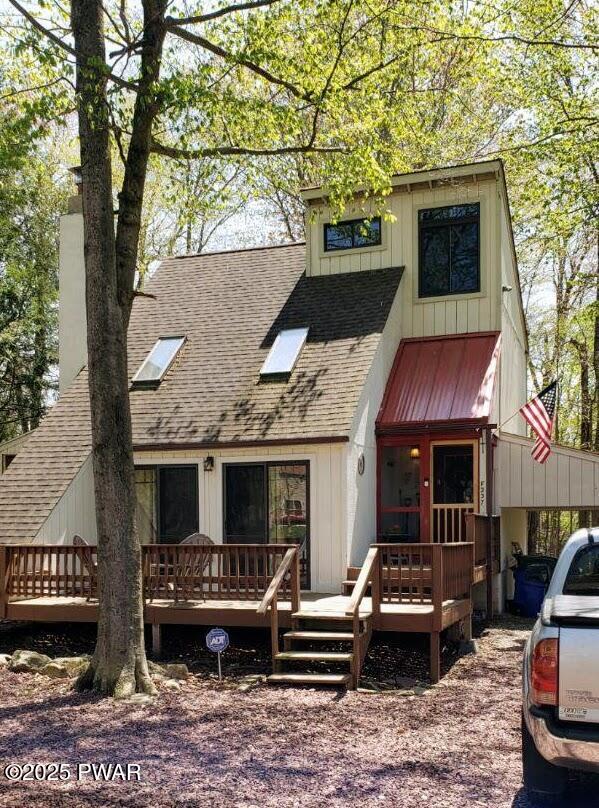 back of house with a wooden deck