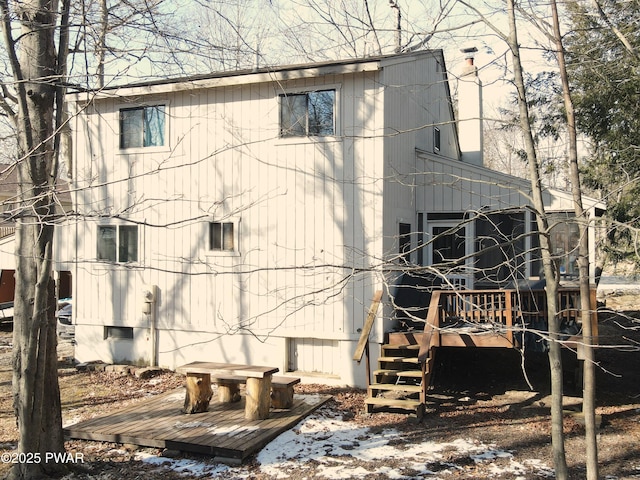 view of snowy exterior featuring a wooden deck