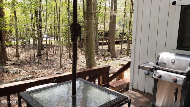 wooden terrace featuring a grill