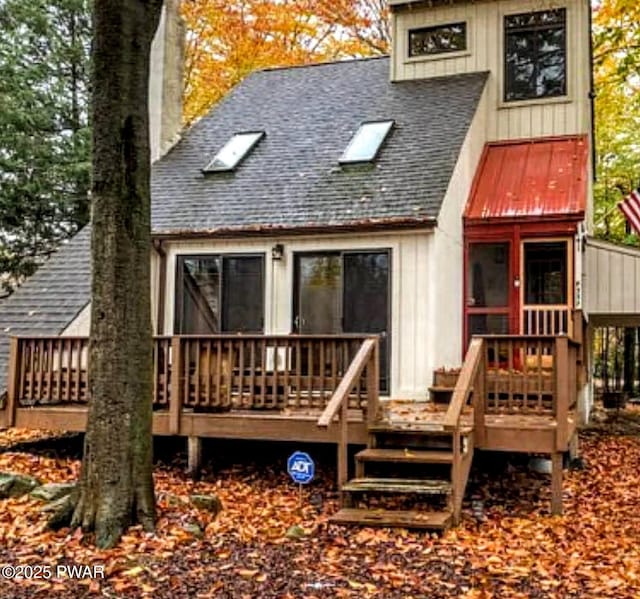 back of property featuring a wooden deck