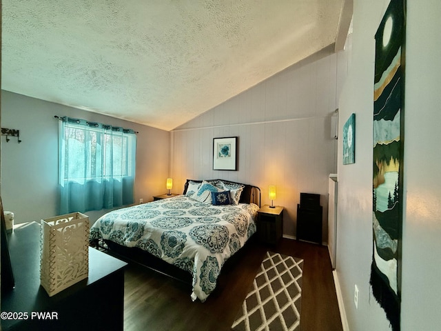 bedroom featuring lofted ceiling, dark hardwood / wood-style floors, and a textured ceiling