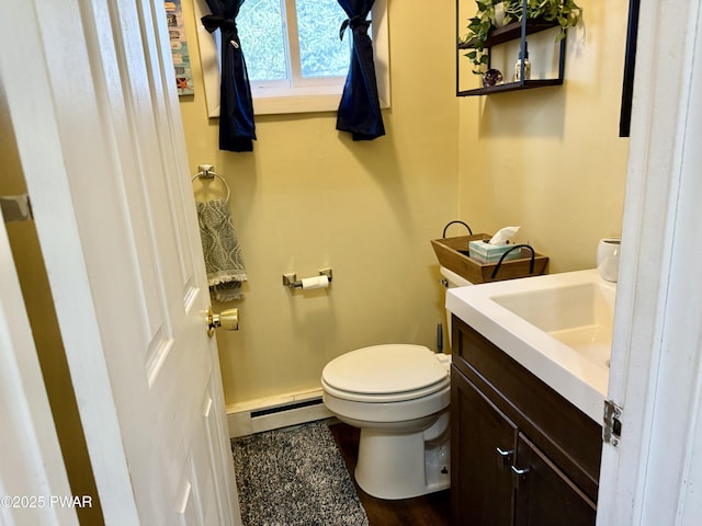 bathroom featuring a baseboard radiator, vanity, and toilet