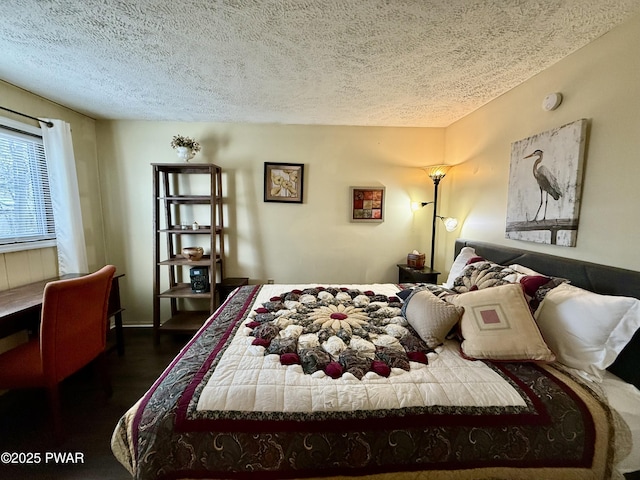 bedroom featuring dark hardwood / wood-style floors and a textured ceiling