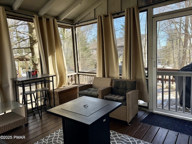 sunroom with lofted ceiling with beams