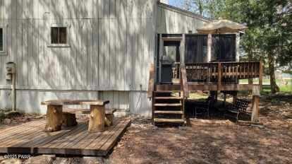 view of home's exterior with a wooden deck