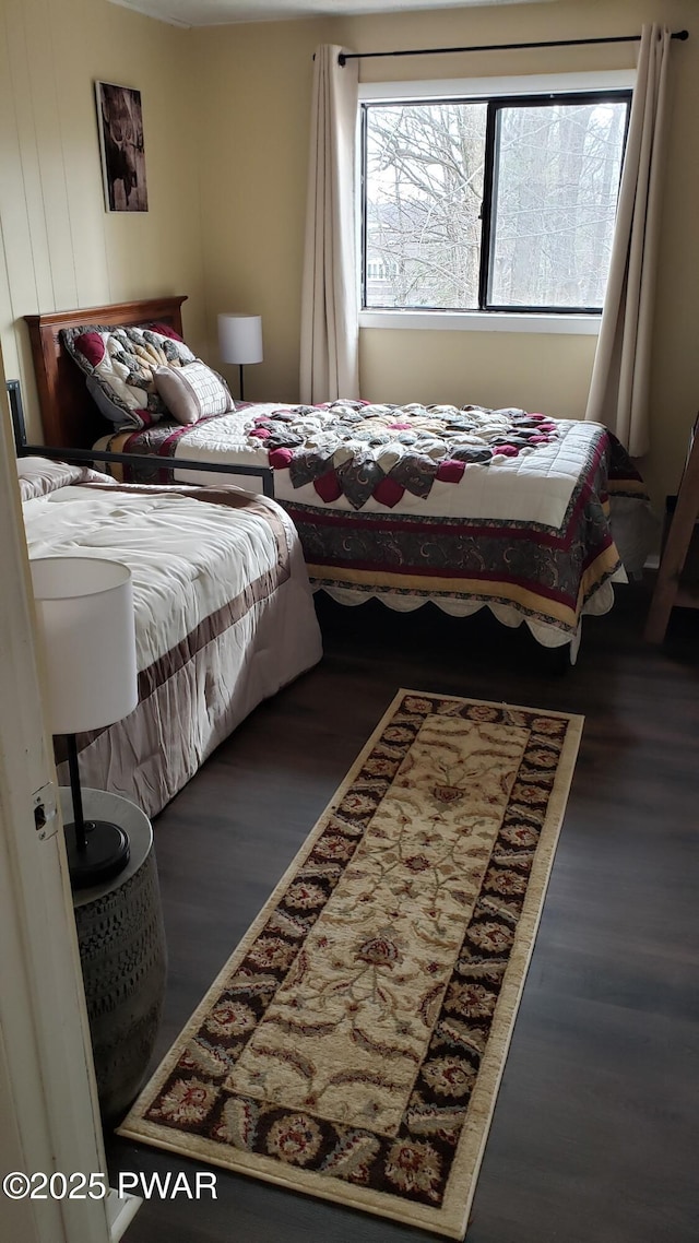 bedroom with dark hardwood / wood-style flooring