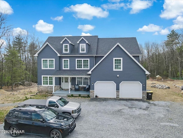 116 Red Bud Ln, Kunkletown, PA 18058 - view of front of house featuring a porch, stone siding, a shingled roof, an attached garage, and driveway