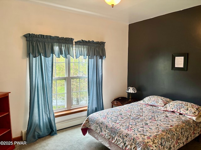 bedroom with carpet flooring, a baseboard radiator, and baseboards