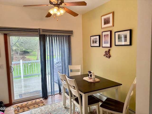 dining space with ceiling fan and wood finished floors