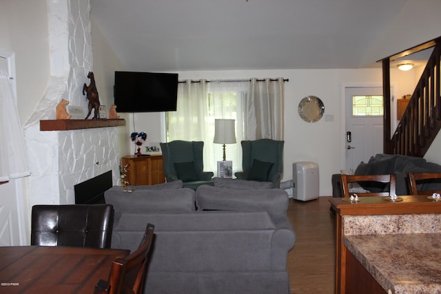 living room featuring dark hardwood / wood-style floors, plenty of natural light, and a fireplace