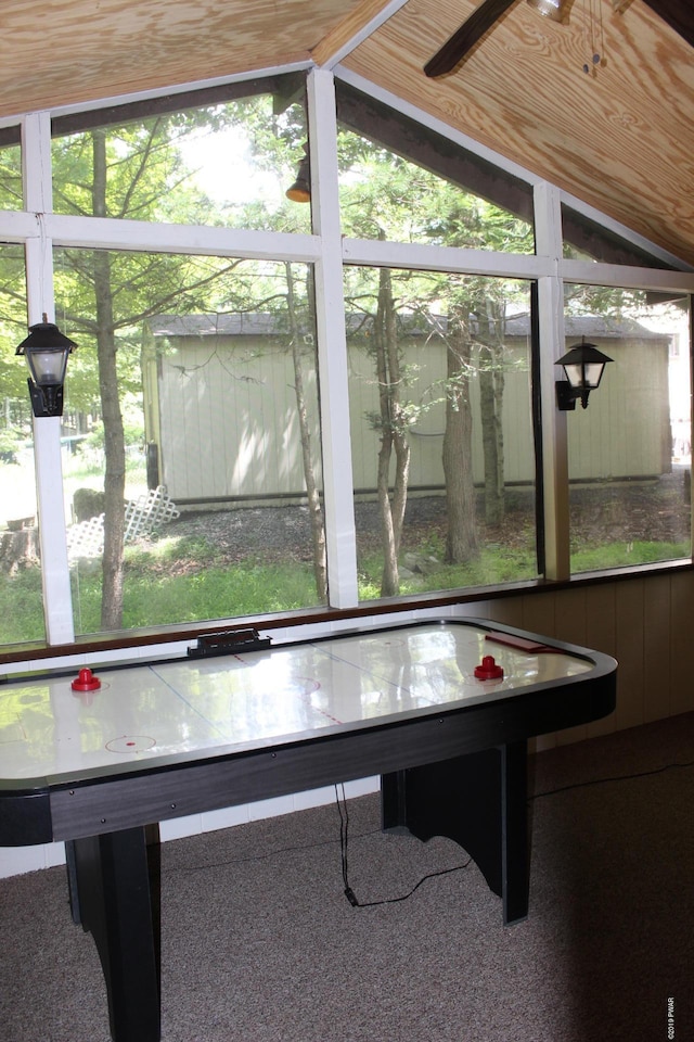 rec room featuring carpet floors, a wealth of natural light, and lofted ceiling