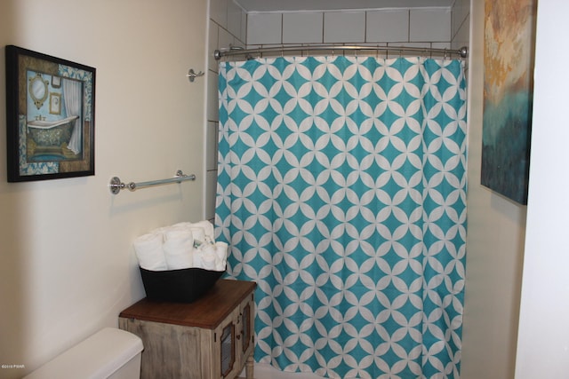 bathroom featuring toilet and walk in shower