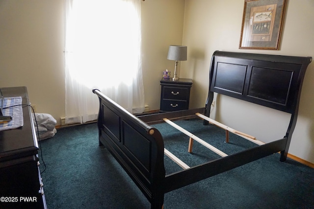 bedroom featuring dark colored carpet and baseboards