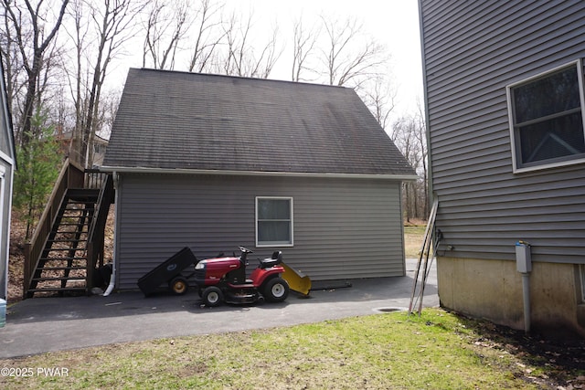 view of side of home featuring a yard and stairs