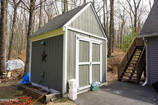 view of shed featuring stairway