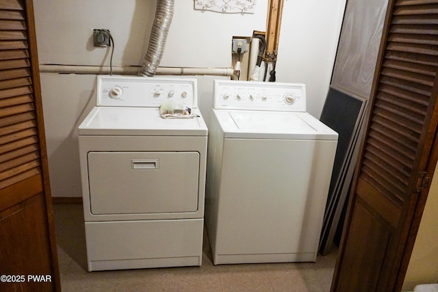 washroom with washing machine and clothes dryer and laundry area