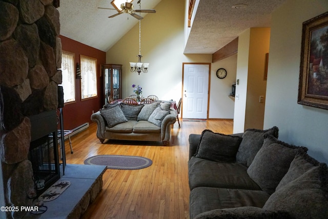 living area featuring wood finished floors, a textured ceiling, high vaulted ceiling, and ceiling fan with notable chandelier