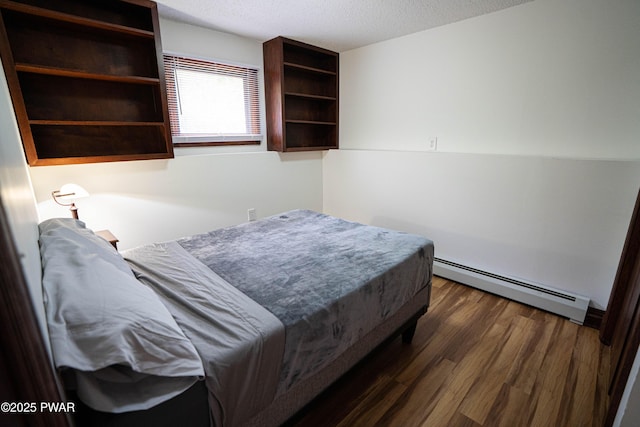 1111 Advent Rd, Lake Ariel, PA 18436 - bedroom with baseboard heating, a textured ceiling, and wood finished floors