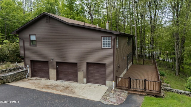 1111 Advent Rd, Lake Ariel, PA 18436 - view of side of property with a garage, asphalt driveway, and view of wooded area