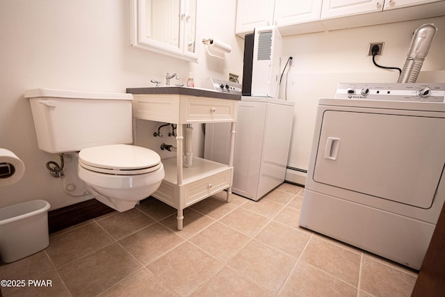1111 Advent Rd, Lake Ariel, PA 18436 - washroom with washer and clothes dryer, a baseboard heating unit, and light tile patterned flooring