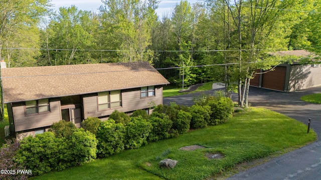 1111 Advent Rd, Lake Ariel, PA 18436 - view of front of property featuring an outdoor structure, a front yard, roof with shingles, and a chimney