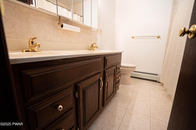 1111 Advent Rd, Lake Ariel, PA 18436 - full bath featuring baseboard heating, double vanity, toilet, tile patterned floors, and a shower with shower curtain