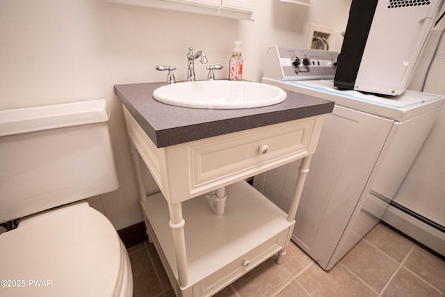 1111 Advent Rd, Lake Ariel, PA 18436 - bathroom with washer / clothes dryer, toilet, tile patterned flooring, baseboard heating, and vanity
